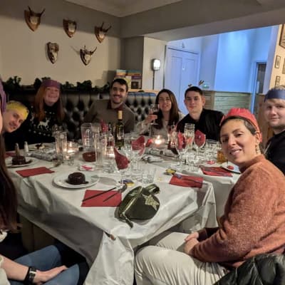 Wyverns members gathered around a table at a festive club social dinner