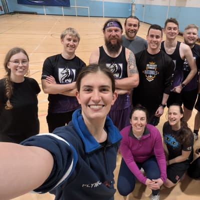 A large group of Wyverns players packed in for a selfie-style team photo after an indoor training session